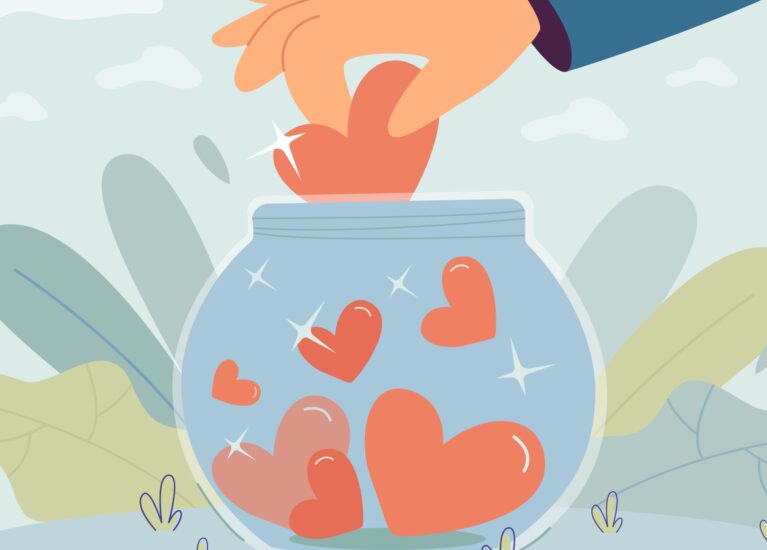 Volunteers hand putting heart in glass donation jar